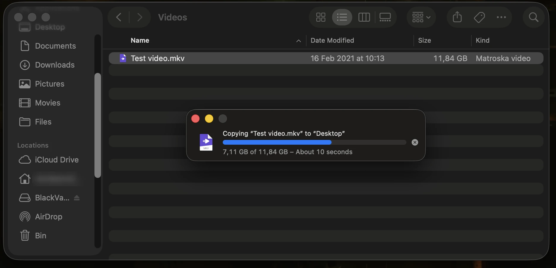 Finder on a Mac in the Videos folder of BlackVault 970 EVO: Test video.mkv, 11.84 GB, being copied to Desktop, 7.11 GB of 11.84 GB done.